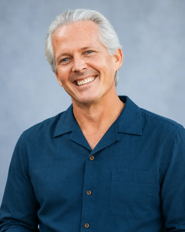 Mark W. Pattison smiling in a navy shirt